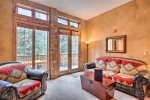 Floor to ceiling windows and a ground level patio
